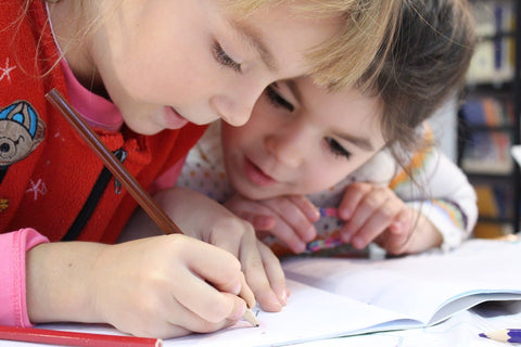 Two children doing homework together
