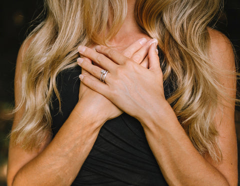 Close up of founder, Laura Meemken, with her hands folded over her heart.
